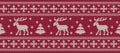 Christmas background. Knitted pattern with deers and fir trees on a red background Royalty Free Stock Photo