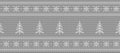 Christmas background. Knitted pattern with fir trees and snowflakes on a gray background