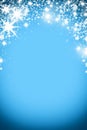 Christmas background with luminous garland with stars, snowflakes and place for text. Blue sparkly holiday background