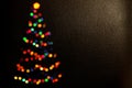 Christmas Background Made of Colorful Christmas Tree Lights Bokeh.Bokeh silhouette of Christmas tree.blur light.Happy Royalty Free Stock Photo