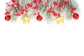 Christmas background made with evergreen tree branches, red holly berries, gold and red baubles isolated on white background. Royalty Free Stock Photo