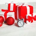 Christmas background, many decorated boxes gifts and alarm clock