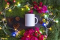 White Mug With Spruce Leaves, Fir Flowers, Paper Flowers (Bougainvillea) and Christmas Lights