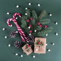 Christmas background. Packing gifts in vintage beige craft paper and natural decor. Branches of fir and red berry . Top view