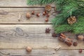 Christmas background with pine branches, nuts, cinnamon sticks a Royalty Free Stock Photo