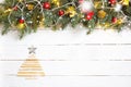 Christmas background with pine cones, fir branches, ornaments and gifts covered with snow. Old white wooden desk with Royalty Free Stock Photo