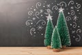 Christmas background with pine tree over chalkboard drawing