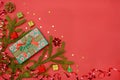 Christmas background - Christmas present green gift box and decoration elements on red background. Creative flat layout and