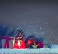 Red Advent candle and Christmas decoration on snow. Royalty Free Stock Photo