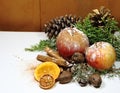 Christmas background red apples golden pineapples green pines and dried fruit Royalty Free Stock Photo