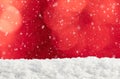 Christmas background with red bokeh, snowdrift and falling snow Royalty Free Stock Photo