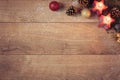 Christmas Background With Red Candles, Golden Cones And Sparkle Balls. Top View, Flat Lay. Winter Holidays Wooden Backdrop With