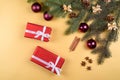 Christmas background with red gift boxes, fir tree branches with glass balls, pine cones, cinnamon sticks and stars anise. Royalty Free Stock Photo