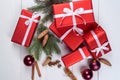 Christmas background with red gift boxes, fir tree branches, pine cones, glass balls, cinnamon sticks and star anise. Royalty Free Stock Photo