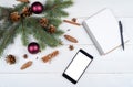 Christmas background with red gift boxes, mobile phone with white screen and blank notebook, copy space. Template for new year Royalty Free Stock Photo