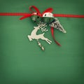 Christmas background with red silk traditional ribbon, white deer, evergreen tree and jingle bells. Royalty Free Stock Photo