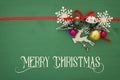 Christmas background with red silk traditional ribbon, white deer, evergreen tree and jingle bells. Royalty Free Stock Photo