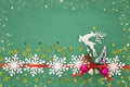 Christmas background with red silk traditional ribbon, white deer, evergreen tree and jingle bells. Royalty Free Stock Photo