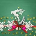 Christmas background with red silk traditional ribbon, white deer, evergreen tree and jingle bells. Royalty Free Stock Photo