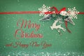 Christmas background with red silk traditional ribbon, white deer, evergreen tree, paper snowflakes and jingle bells. Royalty Free Stock Photo