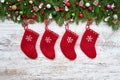 Christmas background. Red Christmas socks on white wooden background with Christmas fir tree. Royalty Free Stock Photo