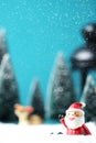 Christmas background with Santa claus, Lantern and christmas trees on table. Royalty Free Stock Photo