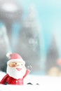 Christmas background with Santa claus, Lantern and christmas trees on table. Royalty Free Stock Photo