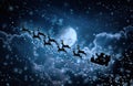 Christmas background. Silhouette of Santa Claus flying on a sleigh pulled by reindeer. Royalty Free Stock Photo
