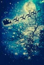 Christmas background. Silhouette of Santa Claus flying on a sleigh pulled by reindeer. Royalty Free Stock Photo