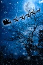 Christmas background. Silhouette of Santa Claus flying on a sleigh pulled by reindeer.