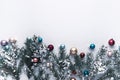 Christmas background with snow decorations and fir tree branch and balls on white top view with copy space Royalty Free Stock Photo