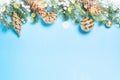 Christmas flatlay background - fir tree and golden decorations on blue. Royalty Free Stock Photo