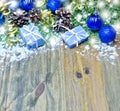 Christmas background snow gifts Christmas balls and streamers and tree branches and cones on wooden background Royalty Free Stock Photo