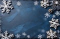 Christmas background with snowflakes and cones on blue slate texture. Top view, copy space. Winter flatlay. Royalty Free Stock Photo