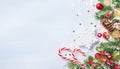 Christmas background with snowy fir branches, decorations, cones and bokeh lights. Holiday banner or card Royalty Free Stock Photo