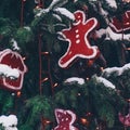 Christmas background. Spruce under real snow, decorations, tinsel, holiday lights. New Year