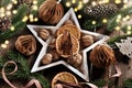 Christmas background with a star shaped bowl with walnuts and spices