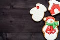 Christmas background with tasty homemade gingerbread cookies with icing on wooden table, top view, flat lay. Snowman, snowflake. Royalty Free Stock Photo