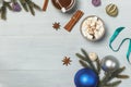 Hot cocoa with melting marshmallows on a light wooden background, with spruce branches and decorations. New Year`s background wit Royalty Free Stock Photo