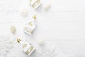 Christmas background for text. Christmas toys on a snowy white wooden background next to snowflakes. Copy space. Royalty Free Stock Photo