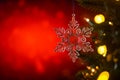 Christmas and background.Toy in the form of a transparent star on a Christmas tree, background for a card, dark red bokeh Royalty Free Stock Photo