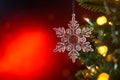 Christmas and background.Toy in the form of a transparent star on a Christmas tree, background for a card, dark red bokeh Royalty Free Stock Photo