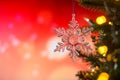 Christmas and background.Toy in the form of a transparent star on a Christmas tree, background for a card, dark red bokeh Royalty Free Stock Photo