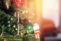 Christmas background tree branch with decorations candy lollipop cane red and green balls, with bokeh sun light Royalty Free Stock Photo