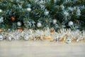 Christmas background with Christmas tree branches, blue and yellow layers and silver tinsel on a wooden background. Copy space for Royalty Free Stock Photo