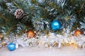 Christmas background with Christmas tree branches, blue and yellow layers and silver tinsel on a wooden background. Copy space for Royalty Free Stock Photo