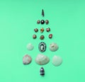 Christmas background with a Christmas tree made of seashells on mint background with copy space. Tropical christmas and new year Royalty Free Stock Photo