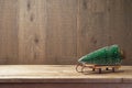 Christmas background with tree on sledges on wooden table