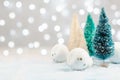 Christmas background with trees, snow and snowballs on a background of blurry lights. Christmas decor on a background Royalty Free Stock Photo