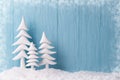 Christmas background with white christmas trees and snow, blue wooden background, snow frame Royalty Free Stock Photo